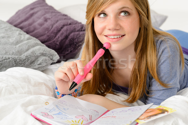 Daydreaming teenager girl writing her journal Stock photo © CandyboxPhoto