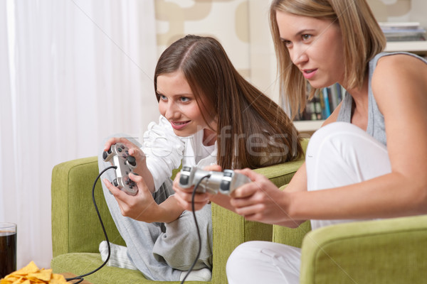 Students - Two female teenager playing video TV game Stock photo © CandyboxPhoto