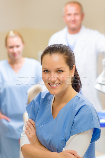 Smiling dental hygienist woman with team Stock photo © CandyboxPhoto