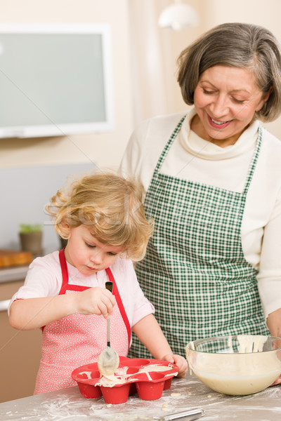 Woman and little girl baking cupcakes together Stock photo © CandyboxPhoto