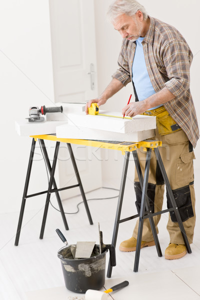 Stock photo: Home improvement - handyman measure porous brick