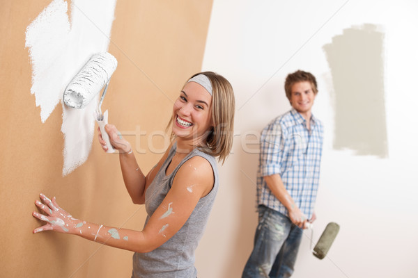 Home improvement: Young couple painting wall Stock photo © CandyboxPhoto