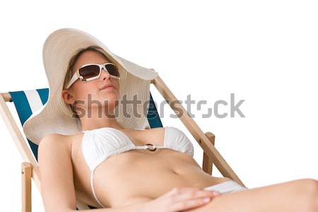 Stok fotoğraf: Plaj · kadın · bikini · şapka · güneşlenme · güneş · gözlüğü