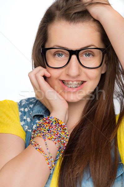 Stock photo: Girl with braces wearing geek glasses isolated