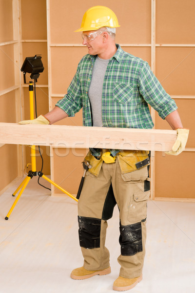 Handyman carpenter mature carry wooden beam Stock photo © CandyboxPhoto