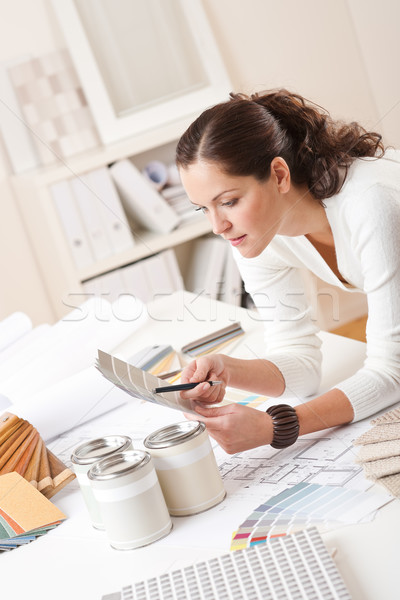 Stock photo: Young female interior designer at office with paint 