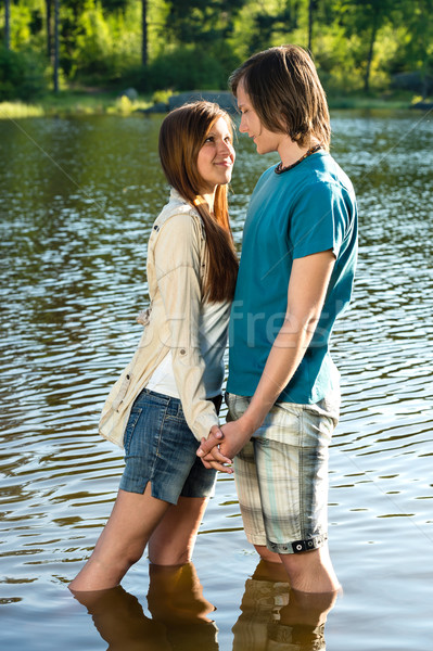 Teens standing in water and holding hands Stock photo © CandyboxPhoto