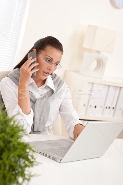 Stock photo: Attractive woman working with laptop