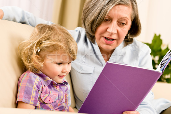 Grandmother and granddaughter read book together Stock photo © CandyboxPhoto