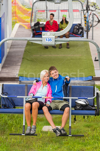 Cuddling couple pointing chair lift in sweatsuits Stock photo © CandyboxPhoto