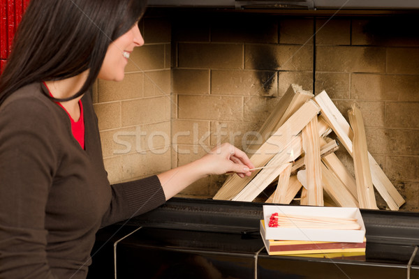 Home fireplace woman lighting up wooden logs Stock photo © CandyboxPhoto