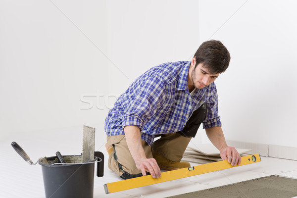 Home tile improvement - handyman with level Stock photo © CandyboxPhoto