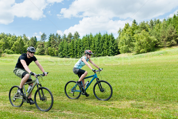 Stock photo: Sport happy couple riding bicycles in coutryside