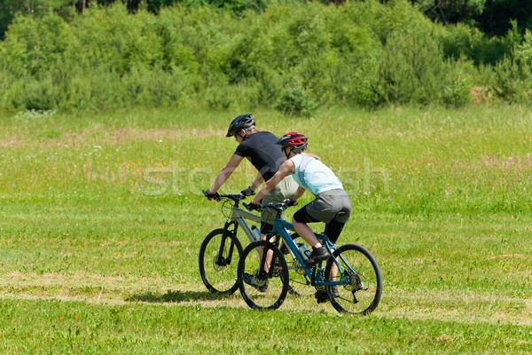 Sport mountain couple biking downhill sunny meadows Stock photo © CandyboxPhoto
