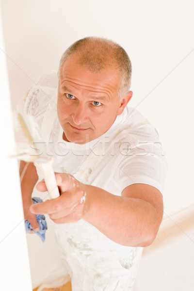 Stock photo: Home decorating mature man painting wall brush