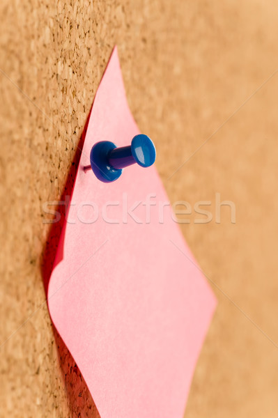 Stock photo: Close up of sticker note with pin on board