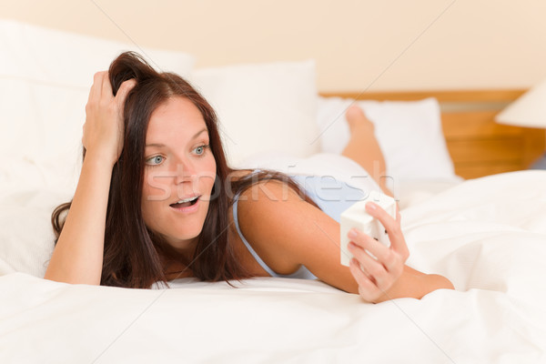 Stock photo: Shocked woman wake-up bed watch alarm clock