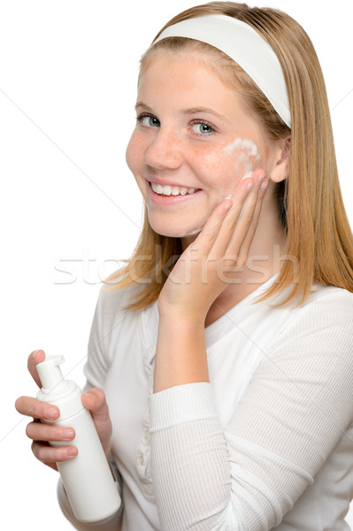 Teenager girl smiling applying moisturizer lotion face Stock photo © CandyboxPhoto