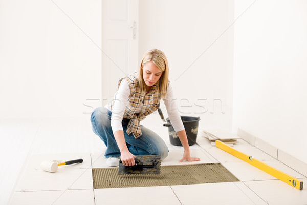 Home improvement, renovation - handywoman laying tile Stock photo © CandyboxPhoto