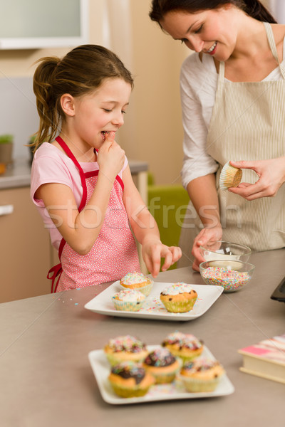 Little girl taste sprinkles decorating cupcake Stock photo © CandyboxPhoto