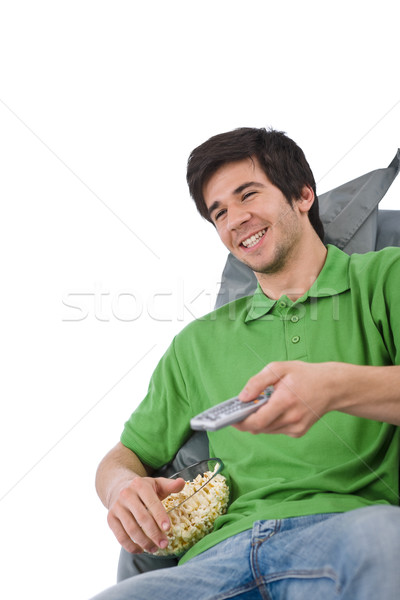 Young man holding remote control watch television Stock photo © CandyboxPhoto