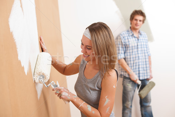 Home improvement: Young man and woman painting wall  Stock photo © CandyboxPhoto