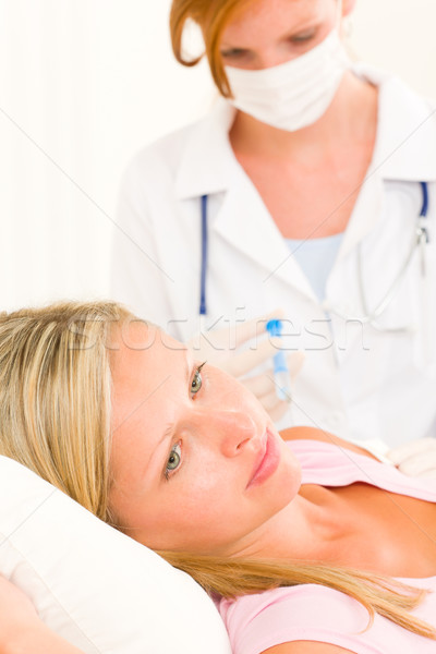 Stock photo: Medical doctor apply injection to woman patient