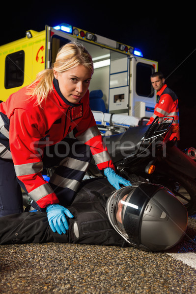 Paramedic assisting motorbike driver at night Stock photo © CandyboxPhoto