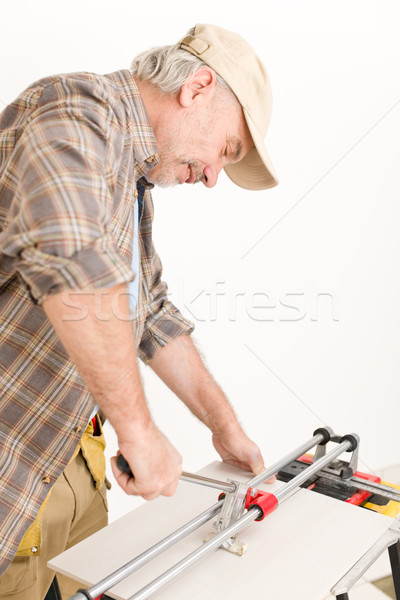 Stock photo: Home improvement - handyman cut tile