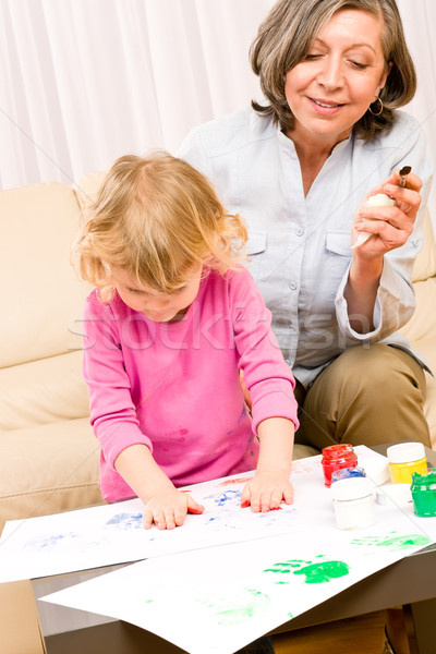 Little girl with grandmother play paint handprints Stock photo © CandyboxPhoto