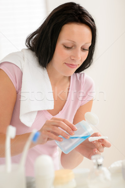 Stock photo: Woman cleaning face with cotton pad bathroom