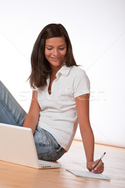 Smiling teenager sitting with laptop and writing notes Stock photo © CandyboxPhoto