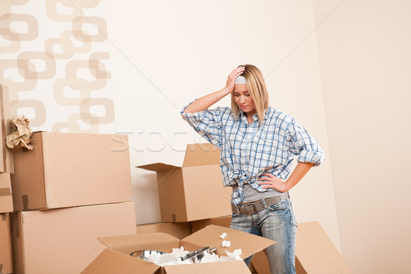 Moving house: Young woman unpacking box Stock photo © CandyboxPhoto