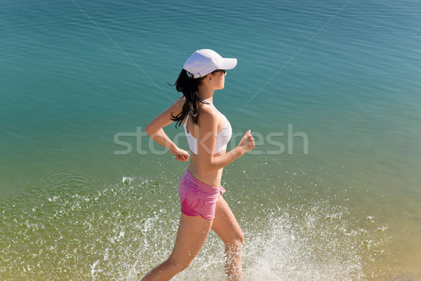 Summer sport fit woman jogging along seashore Stock photo © CandyboxPhoto