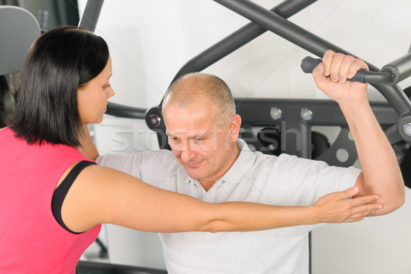 Fitness center trainer assist man exercise back Stock photo © CandyboxPhoto