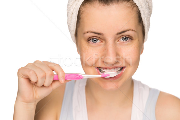 Girl with braces brushing teeth isolated Stock photo © CandyboxPhoto