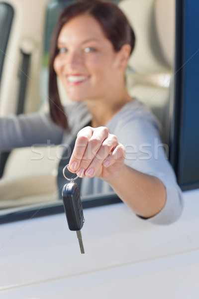 Stock photo: Attractive businesswoman in new car showing keys