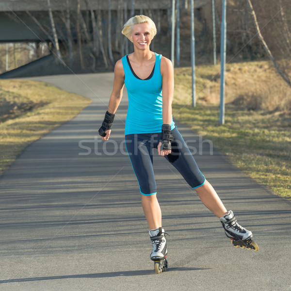 Woman roller skating in park smiling summer Stock photo © CandyboxPhoto