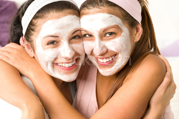 Blissful girls applying mask hugging each other Stock photo © CandyboxPhoto
