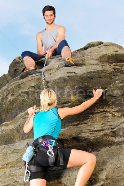 Frau Klettern up rock Mann halten Stock foto © CandyboxPhoto