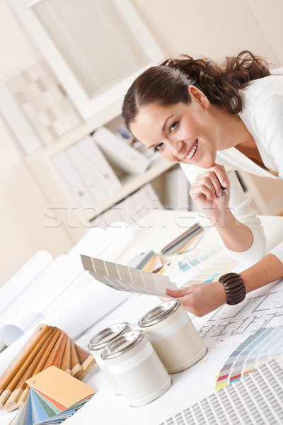 Young Female Interior Designer At Office With Paint Stock