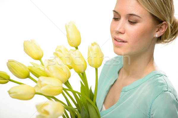 [[stock_photo]]: Femme · regardant · vers · le · bas · jaune · tulipe · fleurs · du · printemps · isolé