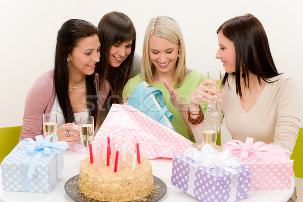 Stock photo: Birthday party - woman unwrap present, celebrating
