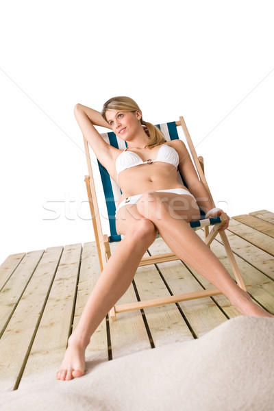 Beach - Woman in bikini sunbathing on deck chair with sand Stock photo © CandyboxPhoto