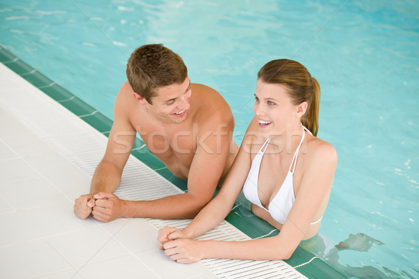 Stock photo: Swimming pool - young cheerful couple have fun