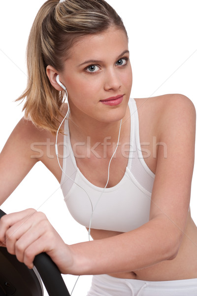 Stock photo: Fitness series - Woman with headphones exercising