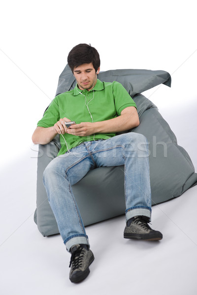 Young man with ear buds listening to music Stock photo © CandyboxPhoto