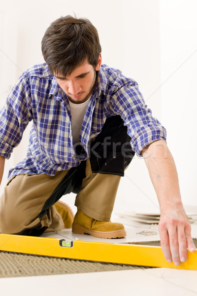 Home tile improvement - handyman with level Stock photo © CandyboxPhoto