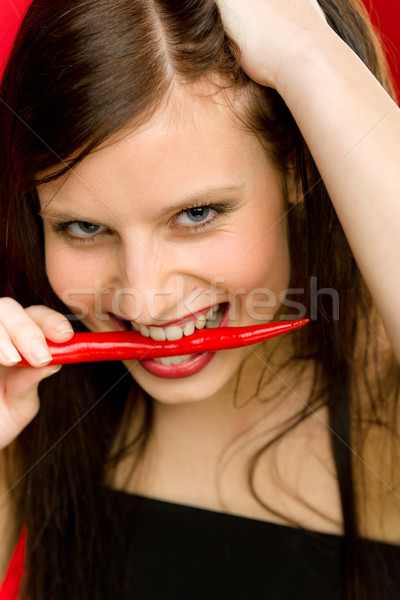 Portret młoda kobieta gryźć czerwony pikantny Zdjęcia stock © CandyboxPhoto