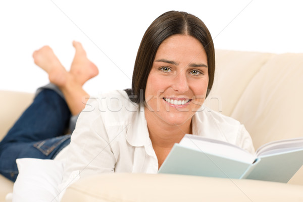 Stock photo: Attractive mid-aged woman read book on sofa 
